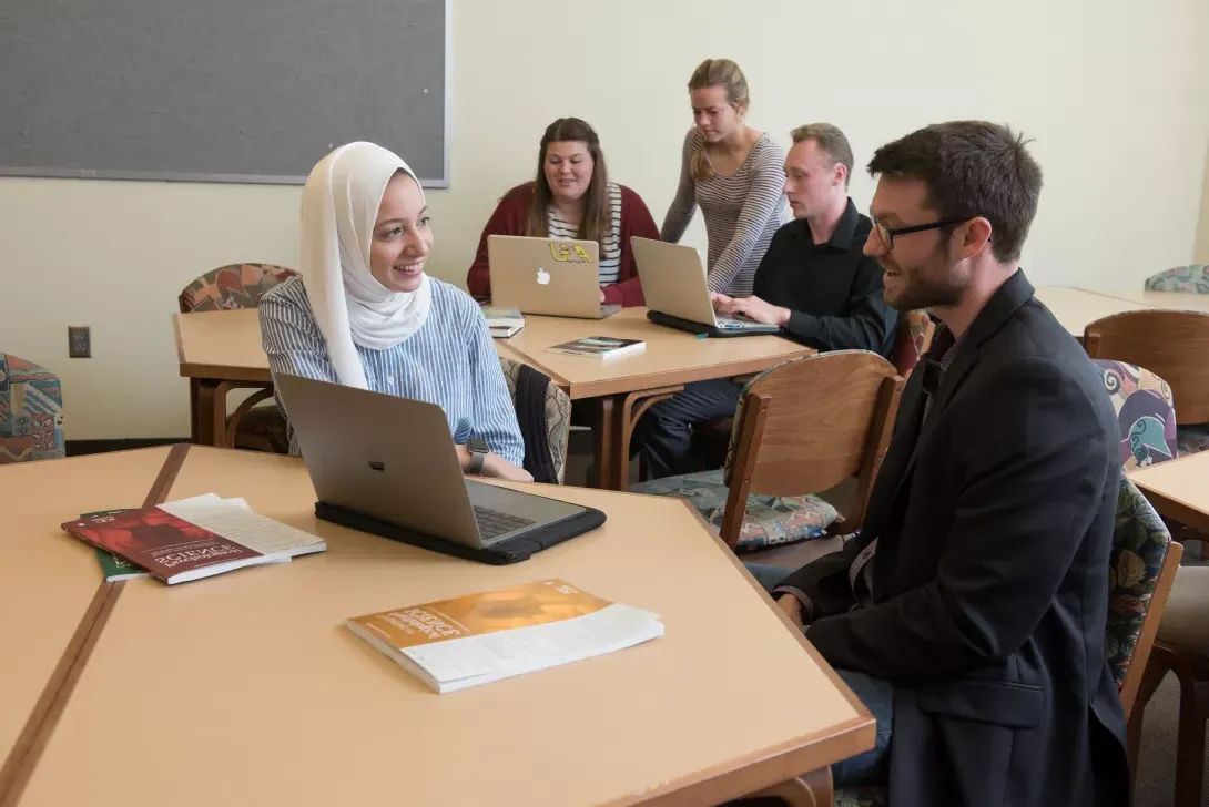 Christopher Chartier speaking with student in International Research Center